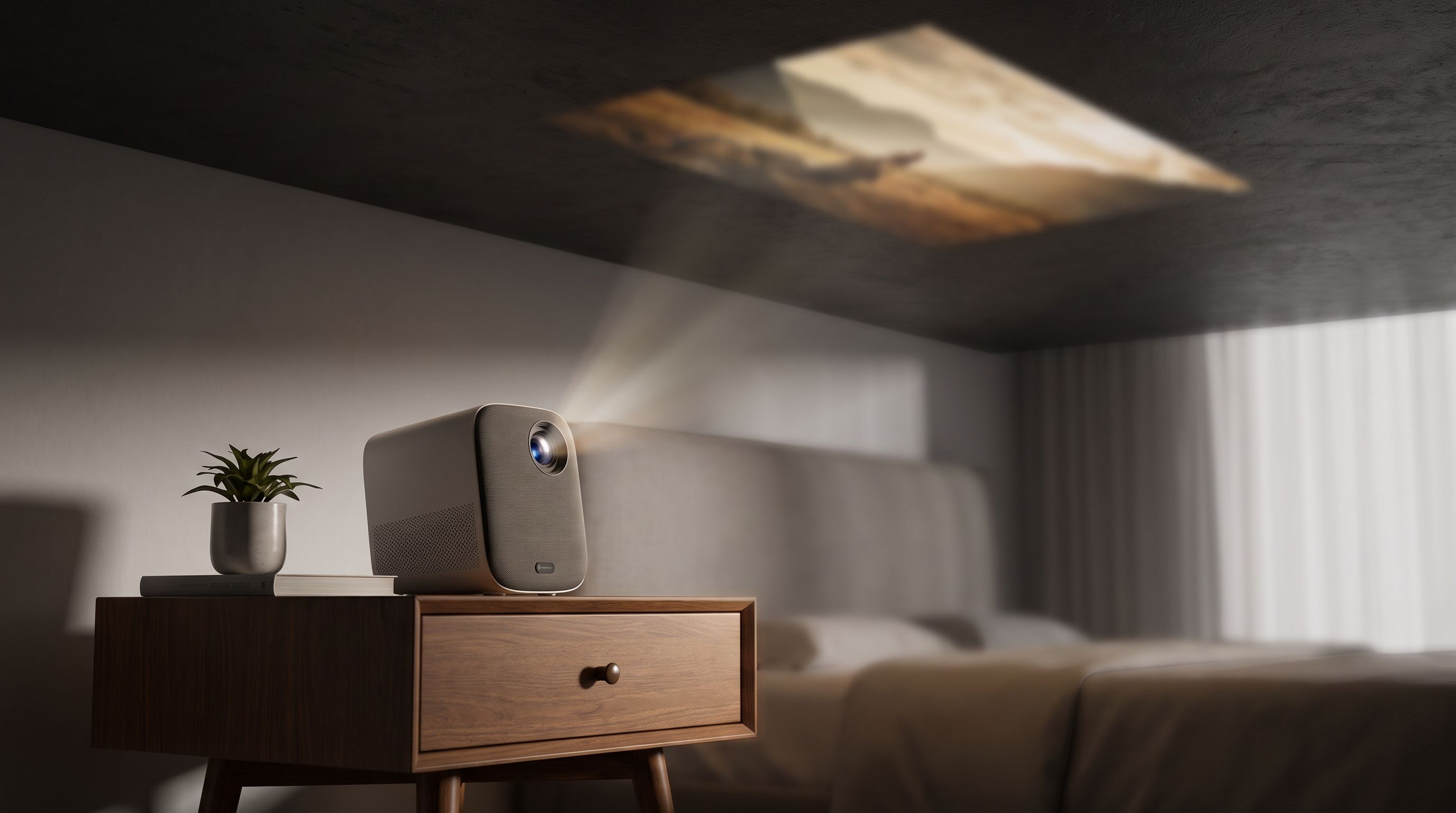 A compact smart projector on a wooden nightstand angled upward, casting a movie onto a dark bedroom ceiling